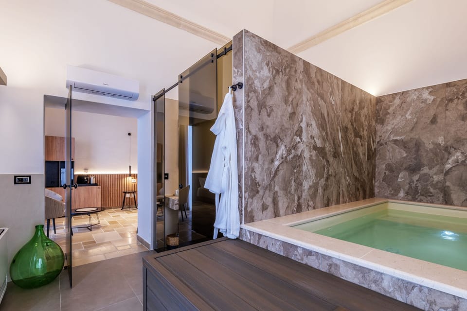Deluxe Suite, Balcony, City View | Bathroom | Shower, free toiletries, hair dryer, bathrobes
