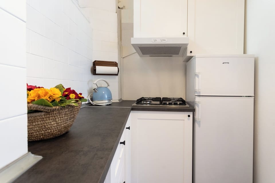 Apartment (1 Bedroom) | Private kitchen | Microwave, espresso maker, electric kettle, highchair