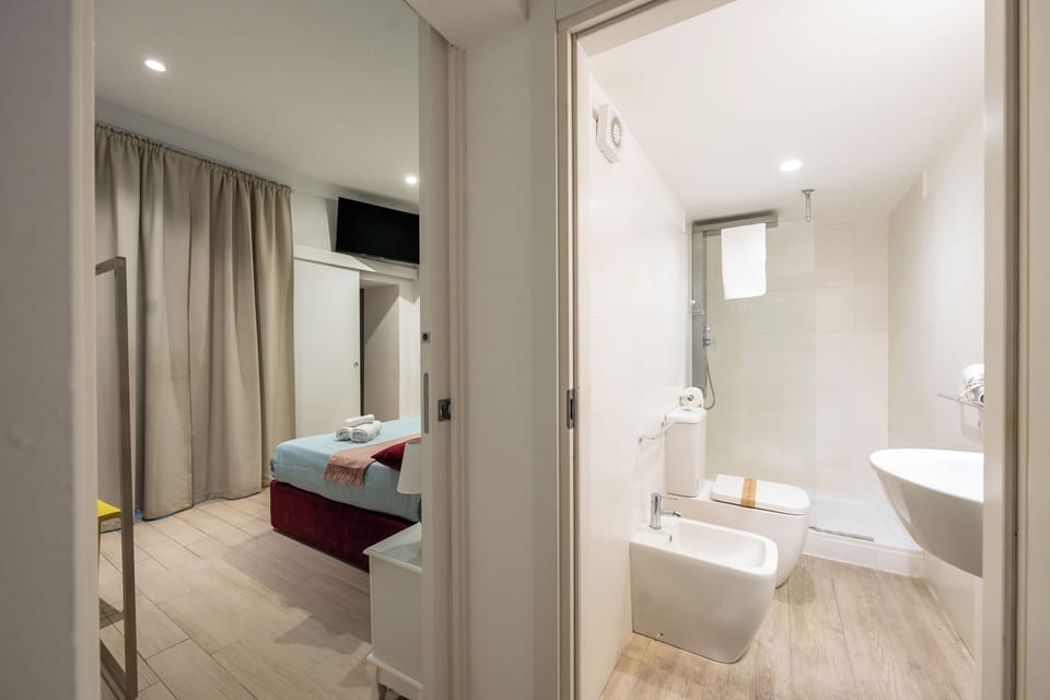 Quadruple Room | Bathroom | Shower, hair dryer, bidet, towels