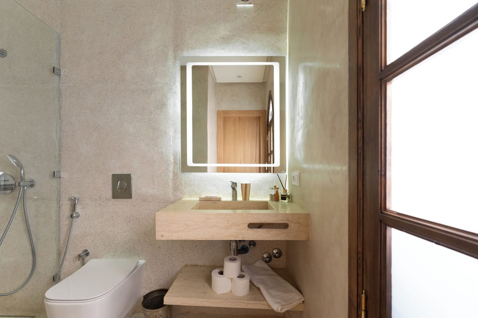 Luxury Suite, Pool View | Bathroom | Shower, hair dryer, bathrobes, slippers