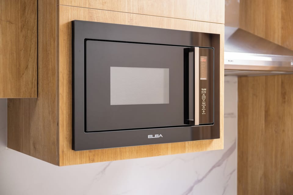 Full-size fridge, microwave, cookware/dishes/utensils, dining table