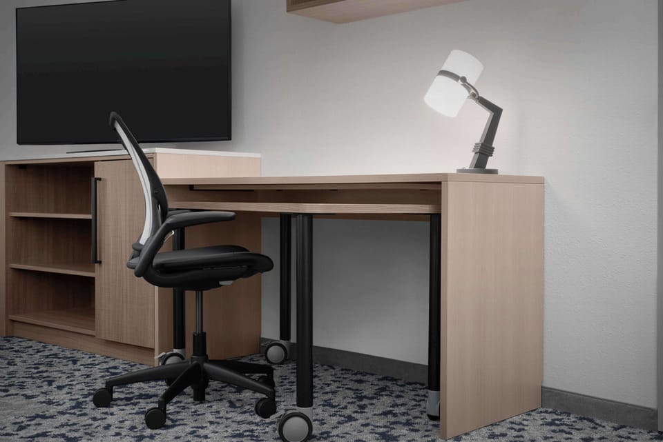 Desk, laptop workspace, cribs (free), WiFi (free)