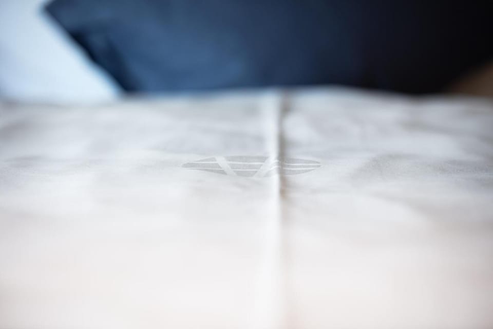 Premium bedding, desk, laptop workspace, soundproofing