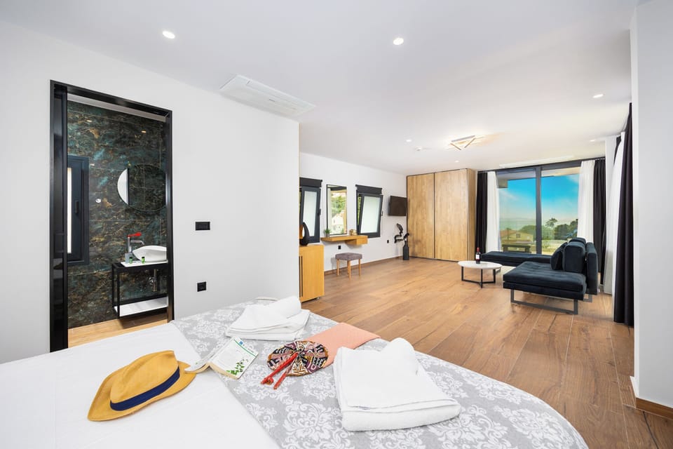 Deluxe Suite, Balcony, Partial Sea View | In-room safe, iron/ironing board, free WiFi