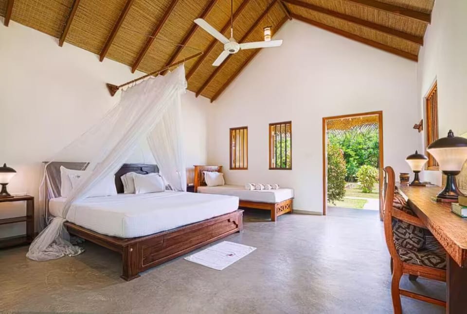 Deluxe Triple Room, Garden View | Hypo-allergenic bedding, desk, laptop workspace, blackout drapes