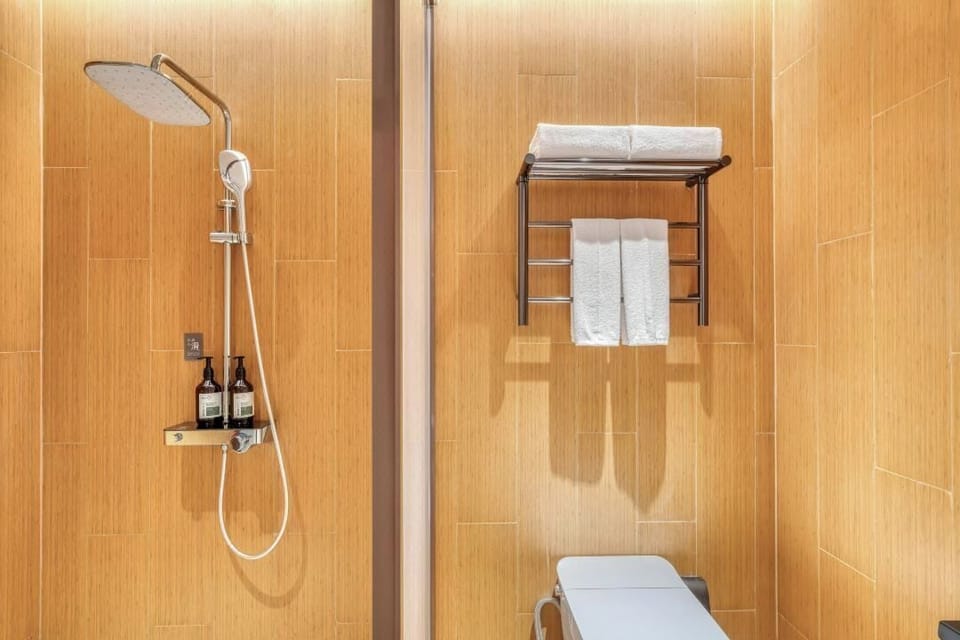 Shower, hair dryer, slippers, towels