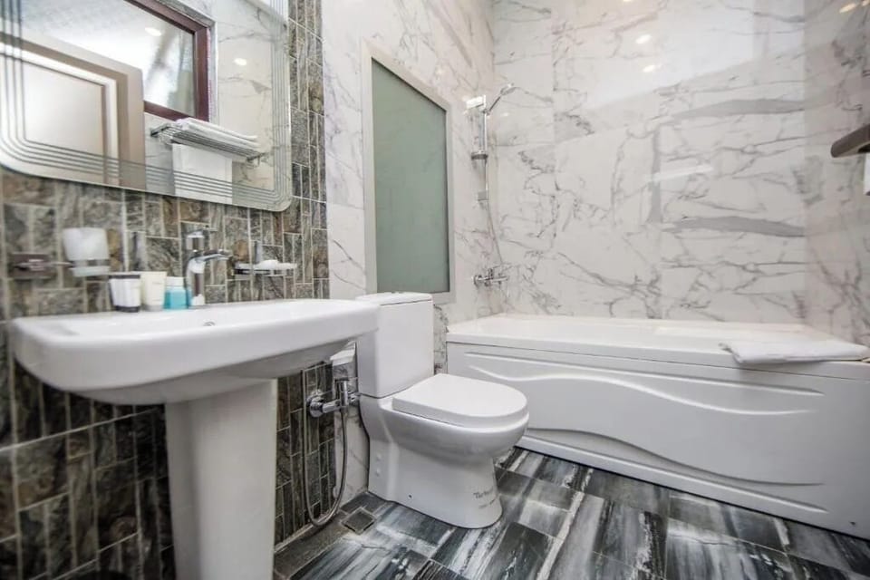 Family Triple Room, City View | Bathroom | Combined shower/tub, hair dryer, slippers, towels