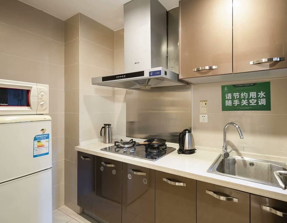 Luxury Studio Suite, 1 King Bed with Sofa bed, Partial Ocean View | Private kitchen | Fridge, stovetop, cookware/dishes/utensils, dining table