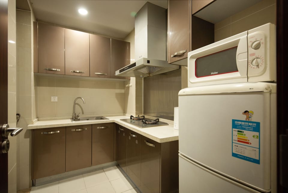 Superior Suite, Kitchen, Partial Ocean View | Private kitchen | Fridge, stovetop, cookware/dishes/utensils, dining table