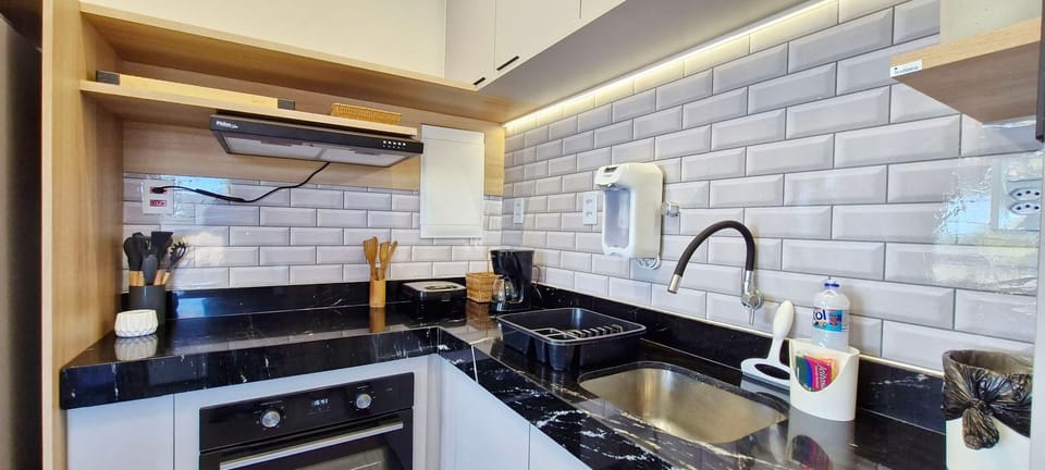 Panoramic Apartment | Private kitchen | Fridge, coffee/tea maker, cookware/dishes/utensils, dining tables