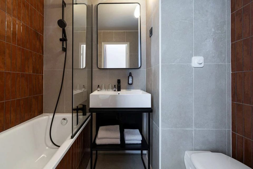 Bathtub, eco-friendly toiletries, hair dryer, towels