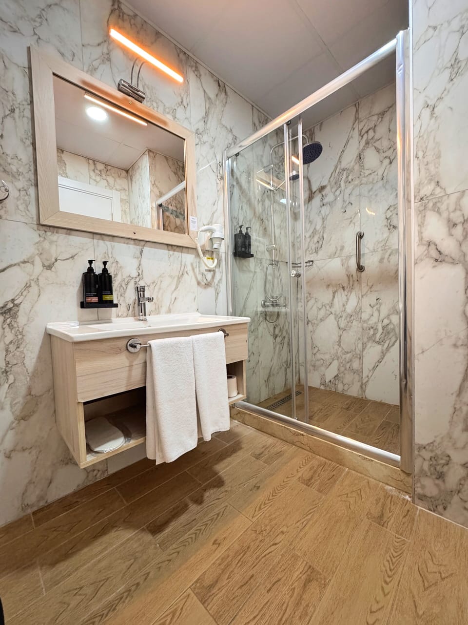 Shower, hair dryer, slippers, towels