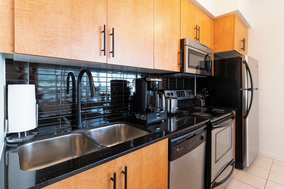 Deluxe Condo, Balcony | Private kitchen | Coffee/tea maker