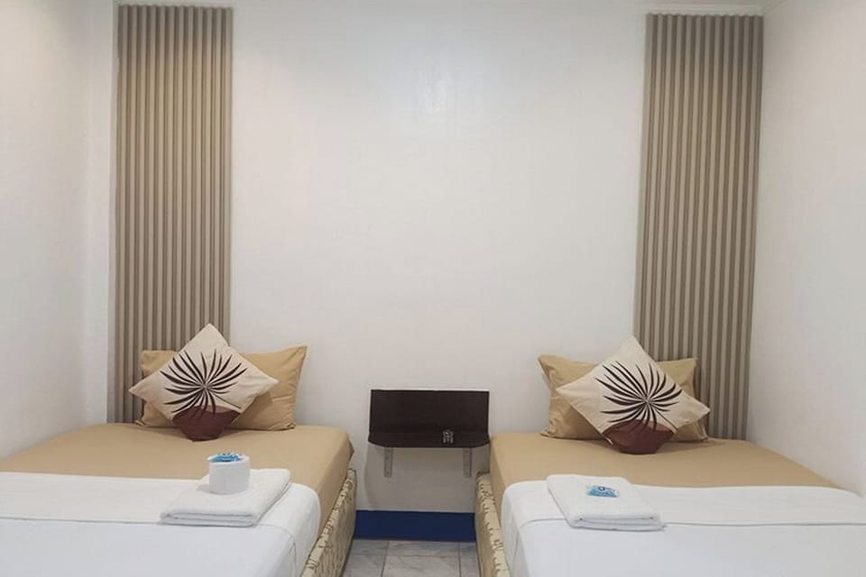 Twin Room | Desk, iron/ironing board, WiFi (free), bed sheets
