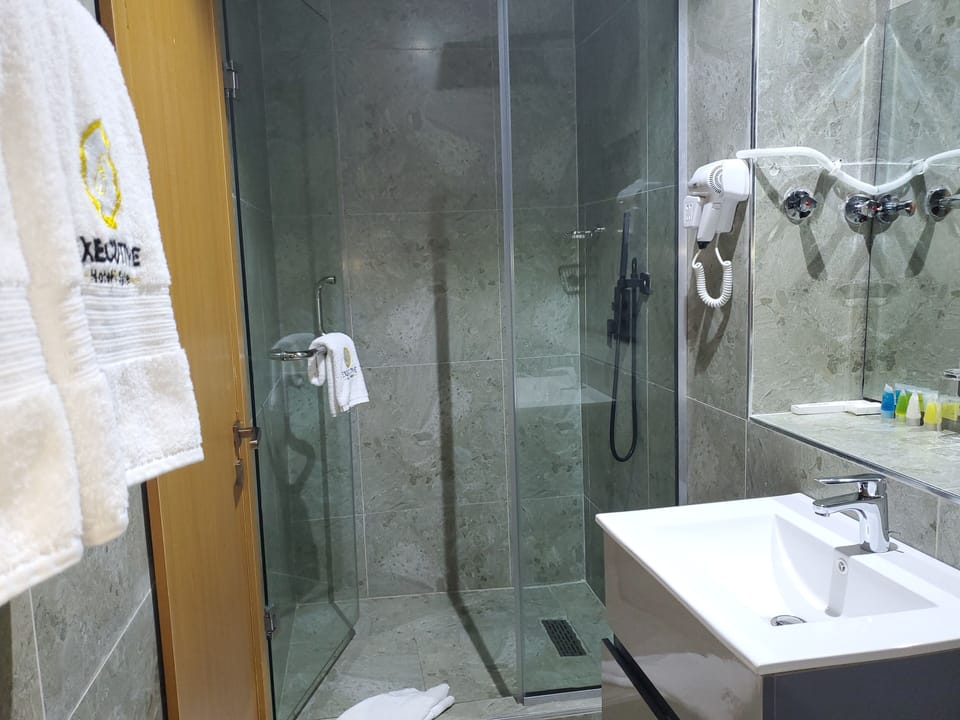 Suite, Non Smoking | Bathroom | Shower, hair dryer, slippers, towels