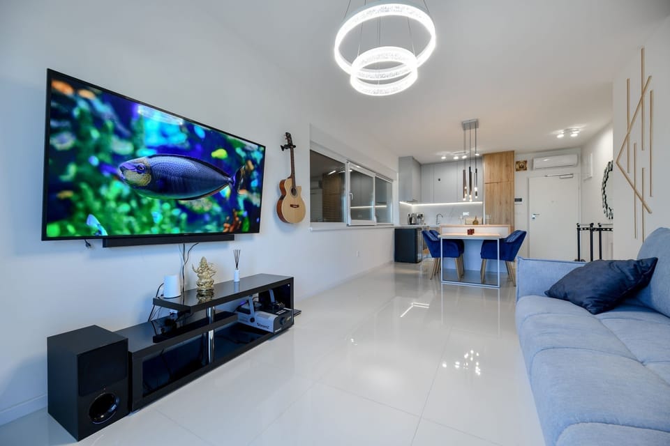 Deluxe Apartment, Sea View | Living area | Flat-screen TV