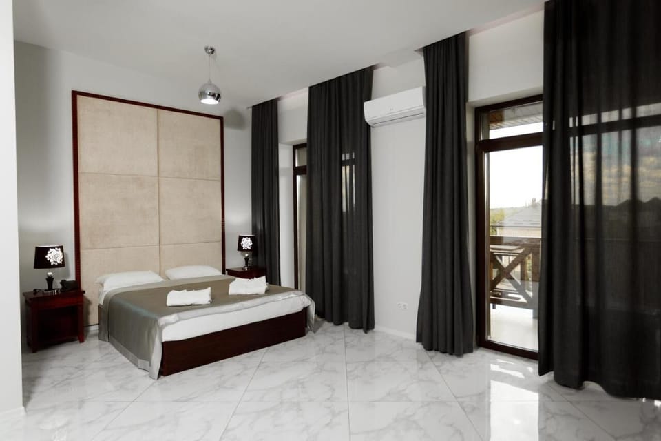 Deluxe Double Room, Balcony | In-room safe, desk, laptop workspace, blackout drapes