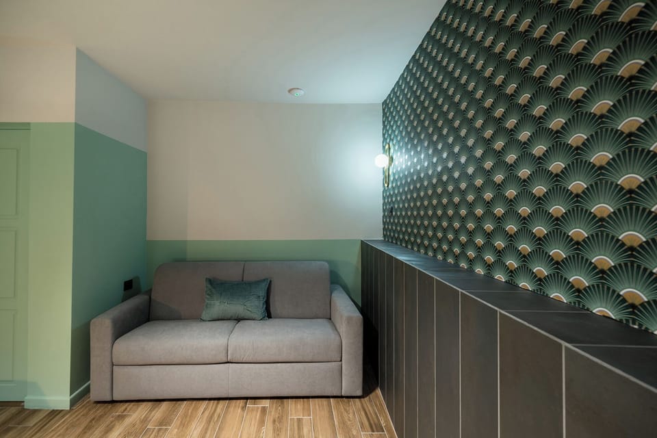 Deluxe Quadruple Room, Balcony | In-room safe, desk, laptop workspace, blackout drapes