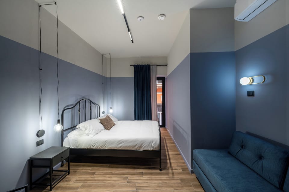 Deluxe Triple Room, Balcony | In-room safe, desk, laptop workspace, blackout drapes