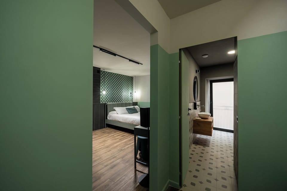 Deluxe Quadruple Room, Balcony | In-room safe, desk, laptop workspace, blackout drapes