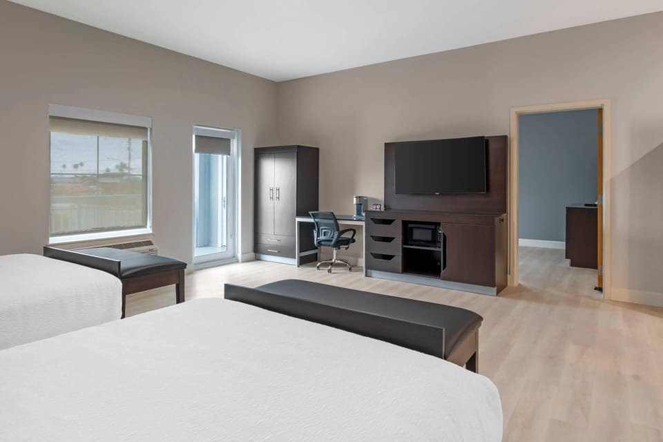 Premium bedding, desk, laptop workspace, blackout drapes