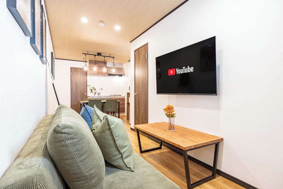 Comfort House | Living area | 50-inch flat-screen TV with cable channels