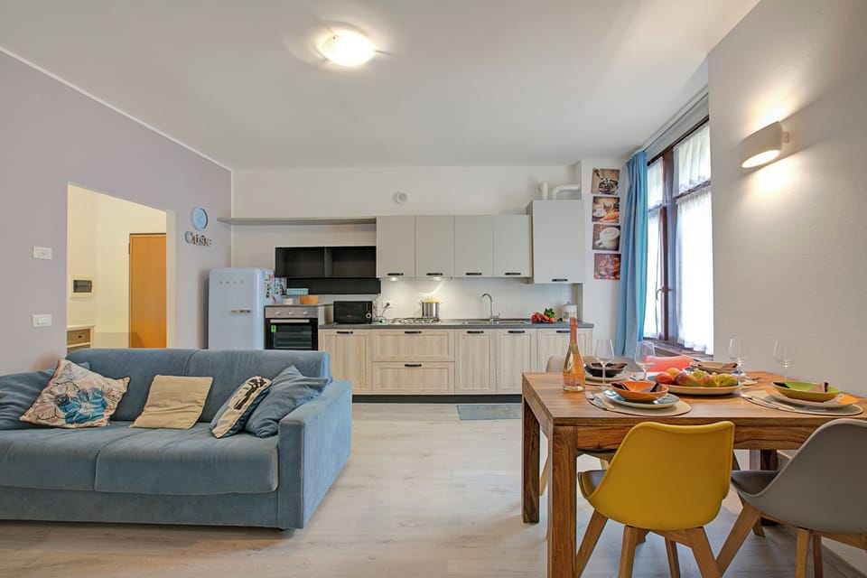Family Apartment, Multiple Bedrooms (Riva Nest) | Living area | 21-inch TV with cable channels