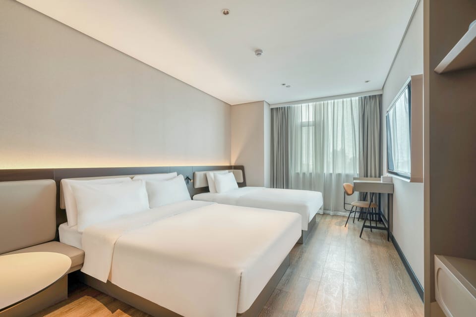 Premium bedding, desk, laptop workspace, blackout drapes