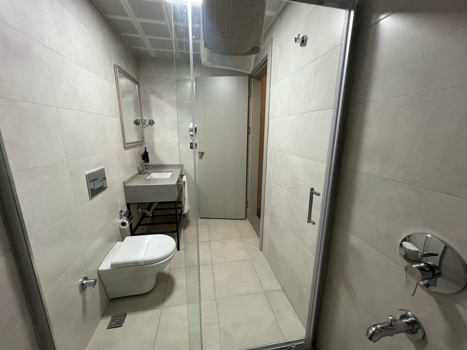 Shower, hair dryer, slippers, towels