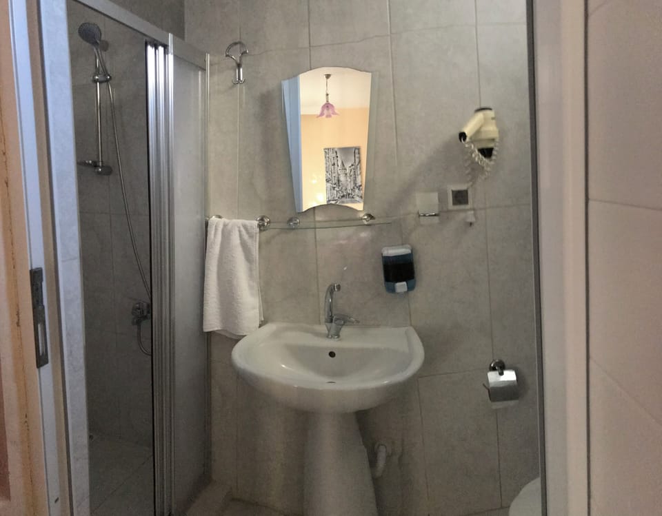 Economy Quadruple Room, Garden View | Bathroom | Shower, hair dryer, slippers, towels