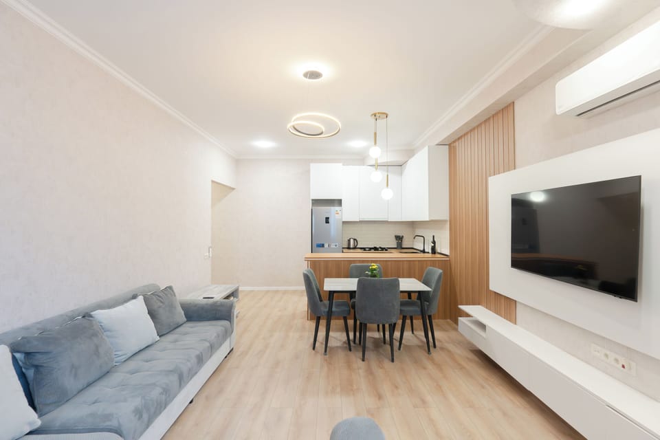 Deluxe Apartment, Balcony, City View | Living area | 43-inch TV with cable channels