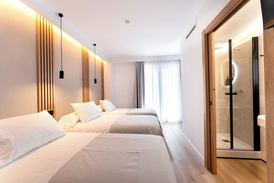 Deluxe Triple Room, City View | Desk, laptop workspace, soundproofing, free WiFi