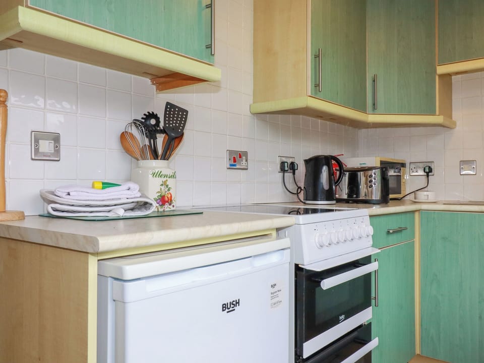 Fridge, electric kettle, cookware/dishes/utensils