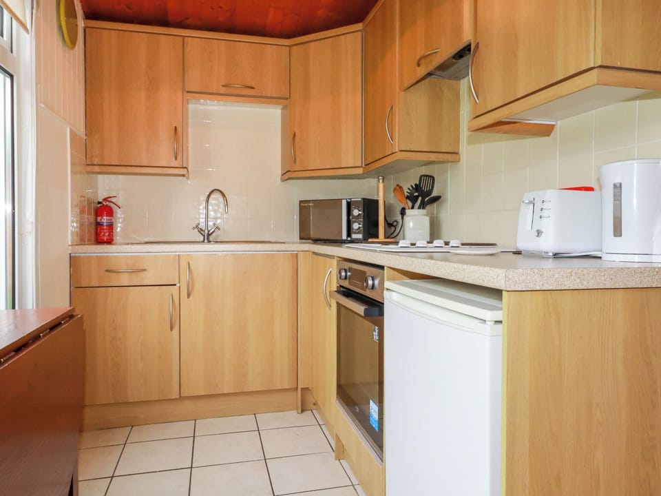 Fridge, electric kettle, cookware/dishes/utensils