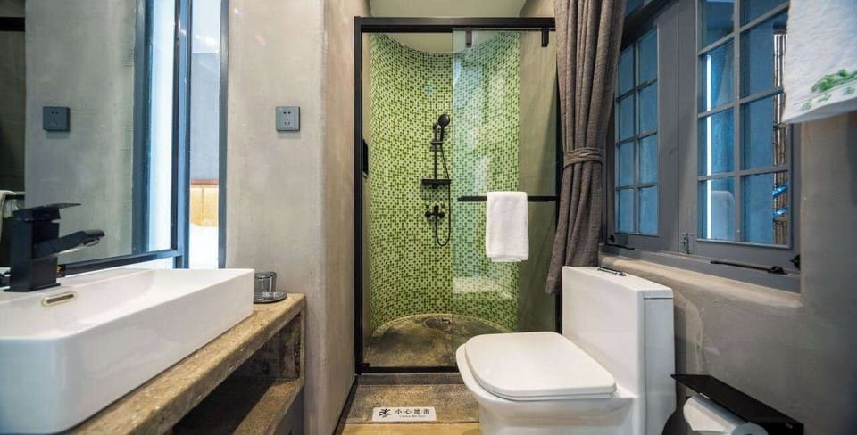 Standard Suite | Bathroom | Hair dryer, slippers, towels, soap