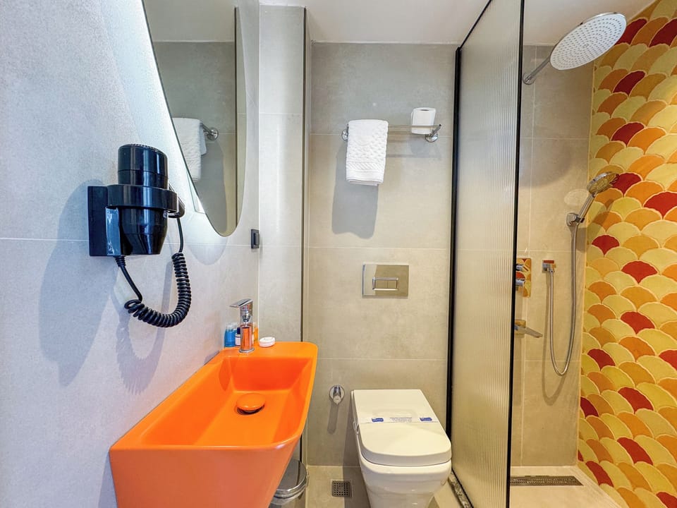 Shower, hair dryer, slippers, towels