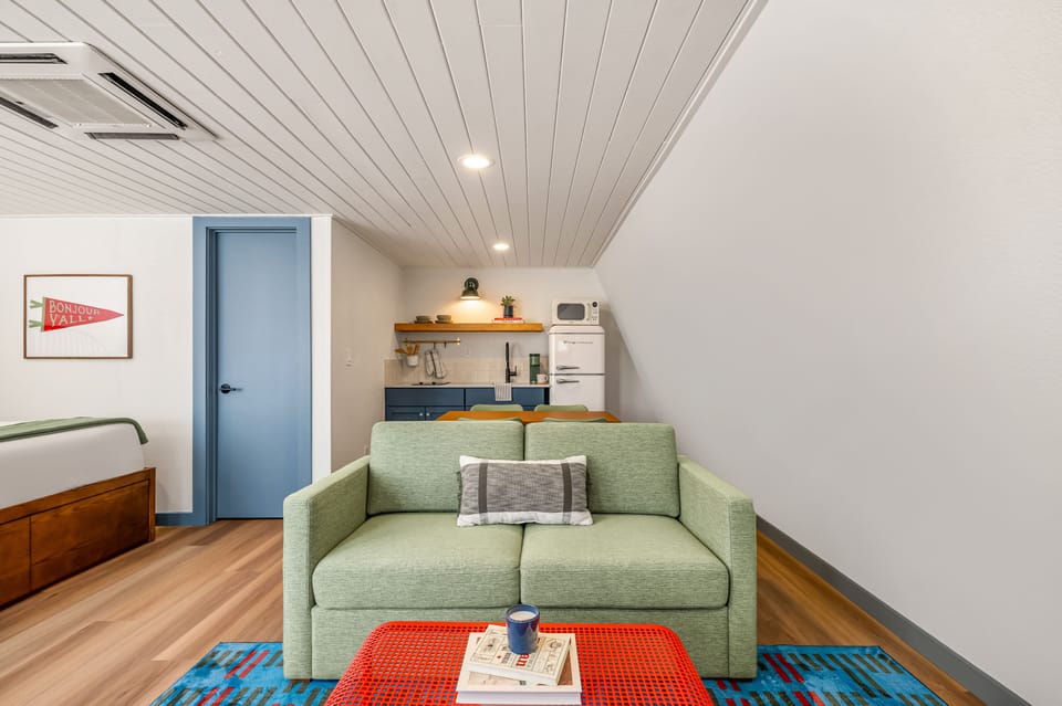Deluxe Double Room, 2 Queen Beds | Living area | 27-inch TV with cable channels