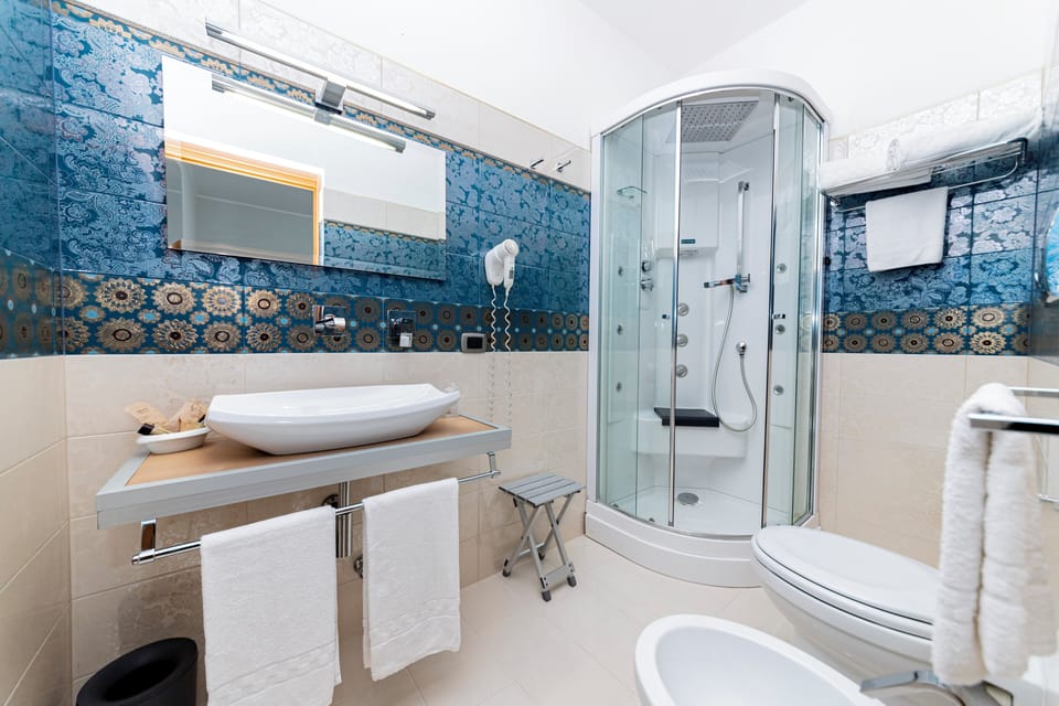 Superior Room, Balcony, Sea View | Bathroom | Shower, hair dryer, bidet, towels