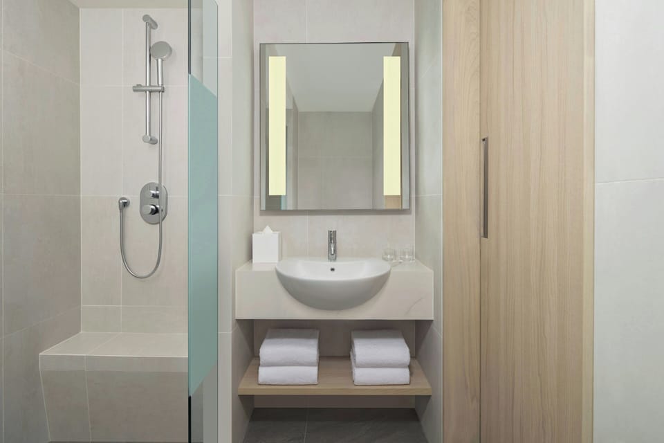 Shower, hair dryer, slippers, towels