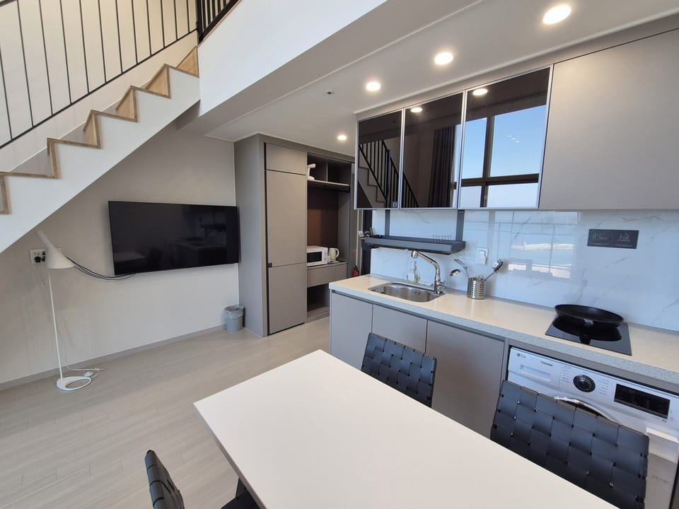 Marina Grand Loft | Private kitchenette | Fridge, electric kettle, freezer, dining table