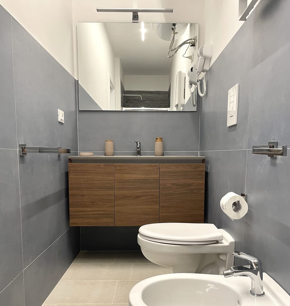 Quadruple Room | Bathroom | Shower, hair dryer, bidet, towels