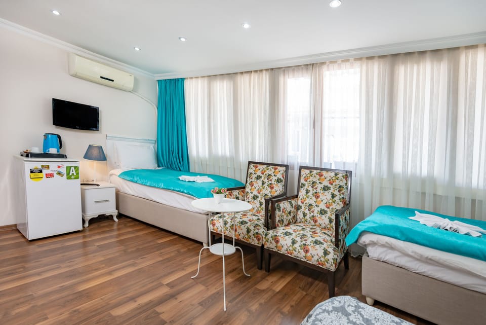 Family Room | Minibar, iron/ironing board, free WiFi, bed sheets