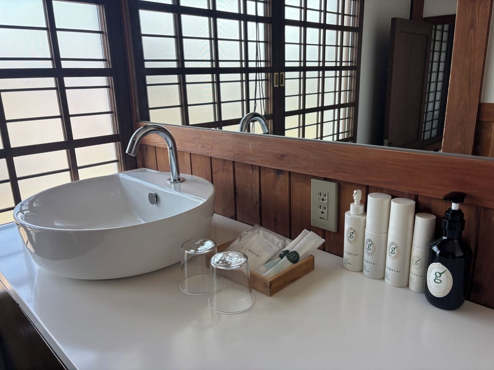 OMOYA EAST | Bathroom | Hair dryer, towels, shampoo, toilet paper