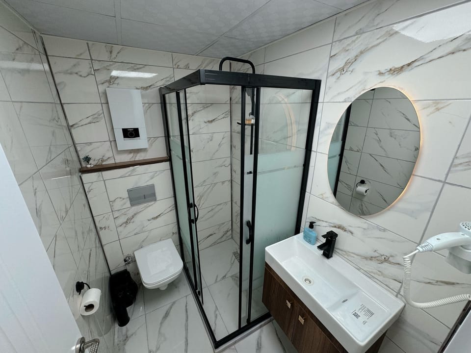 Shower, hair dryer, slippers, towels