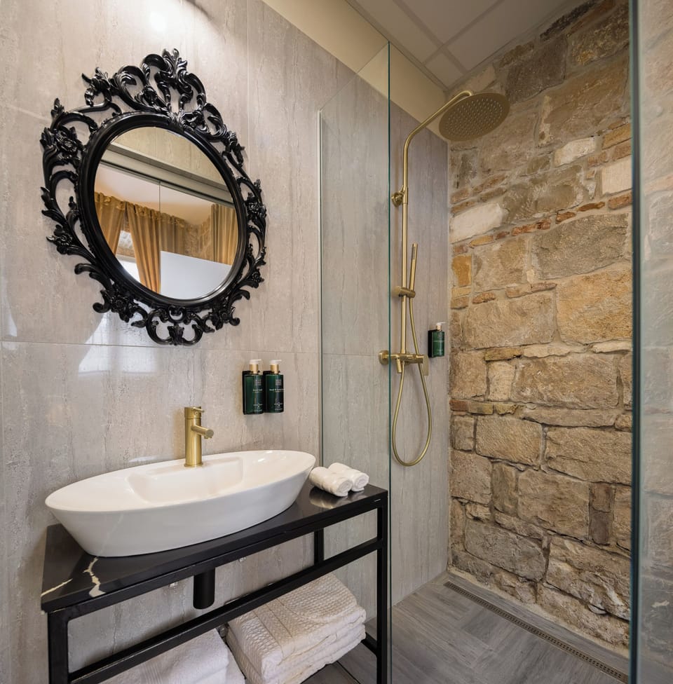 Luxury Room 1 | Bathroom | Shower, hair dryer, slippers, towels