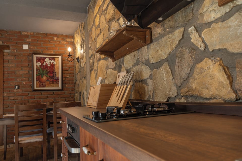 Superior Suite, Courtyard View | Private kitchen | Fridge, stovetop, cookware/dishes/utensils