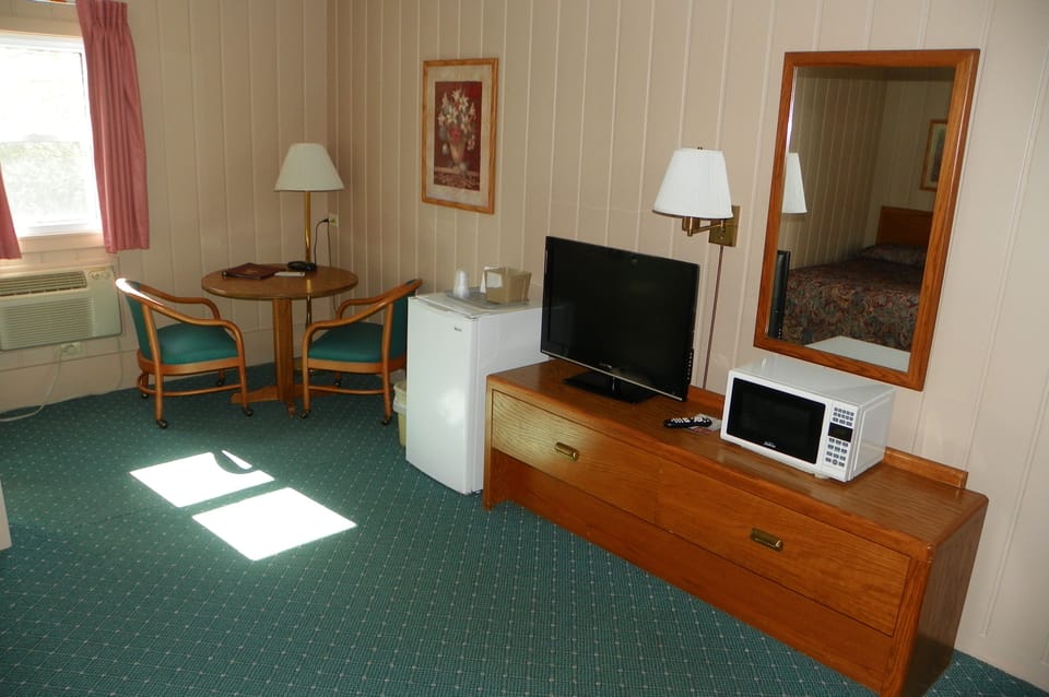 Room, 2 Double Beds | Living area | Flat-screen TV