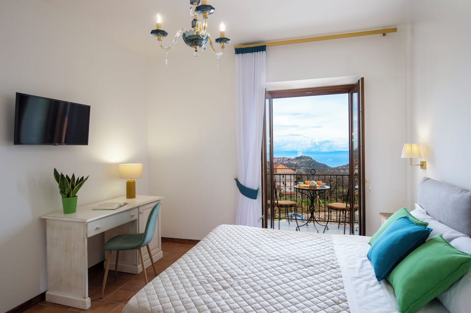 Deluxe Quadruple Room, Sea View | In-room safe, desk, laptop workspace, blackout drapes