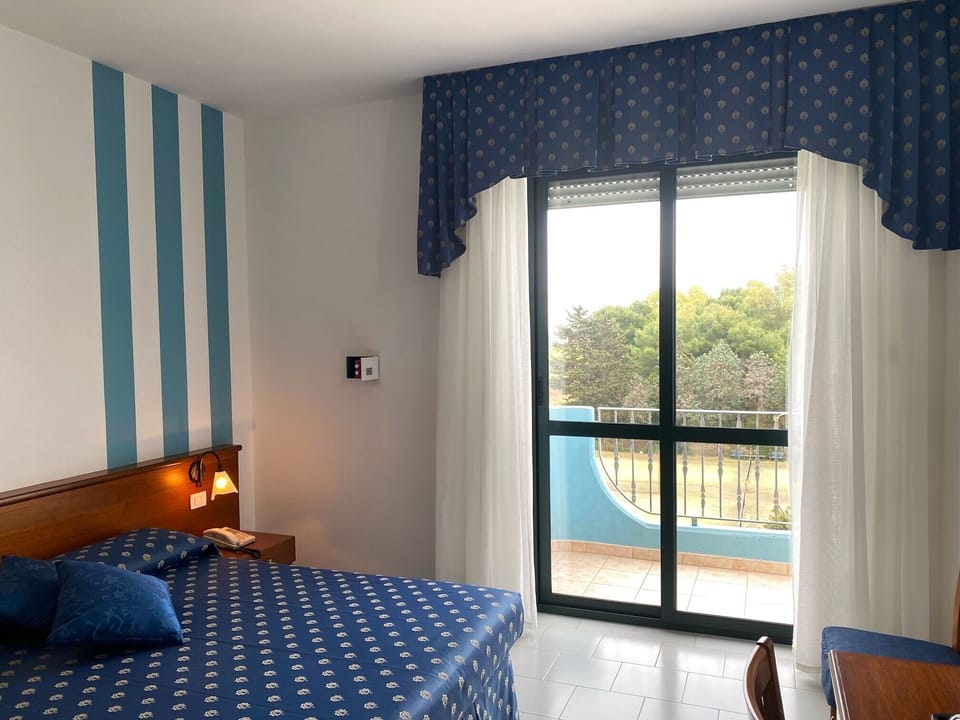 Deluxe Double Room, Balcony | In-room safe, desk, laptop workspace, blackout drapes