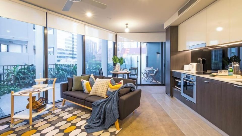 Apartment, 1 Bedroom (QBN550-607) | Living area | Flat-screen TV